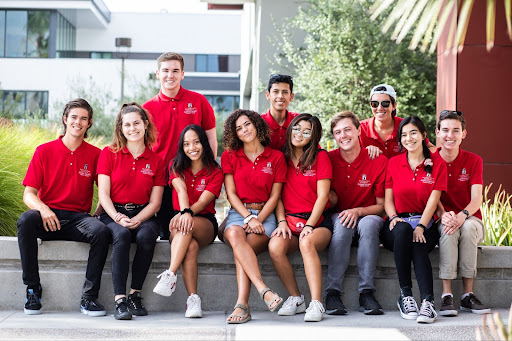 smiling students with red Aztec shirts